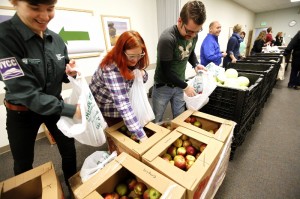 Vermont Youth Conservation Corps staff member Clarice Cutler, left, works with UVM Health Network – Central Vermont Medical Center Health Care Share team members, Andrea Hazuda and Mike Kennedy to bag apples for people in need during the Vermont Foodbank’s Veggie VanGo mobile food pantry. More than 150 people turned out for free, fresh groceries during the first monthly event at the hospital in Berlin. The next mobile food pantry is scheduled for February 26 from 9 to 11 a.m.